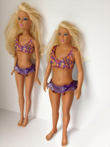 The Barbie on the left looks like the typical toy that most girls or boys play with as children. The Barbie on the right is a newly developed version that represents what 'real' women look like, compared to the common Barbie. 